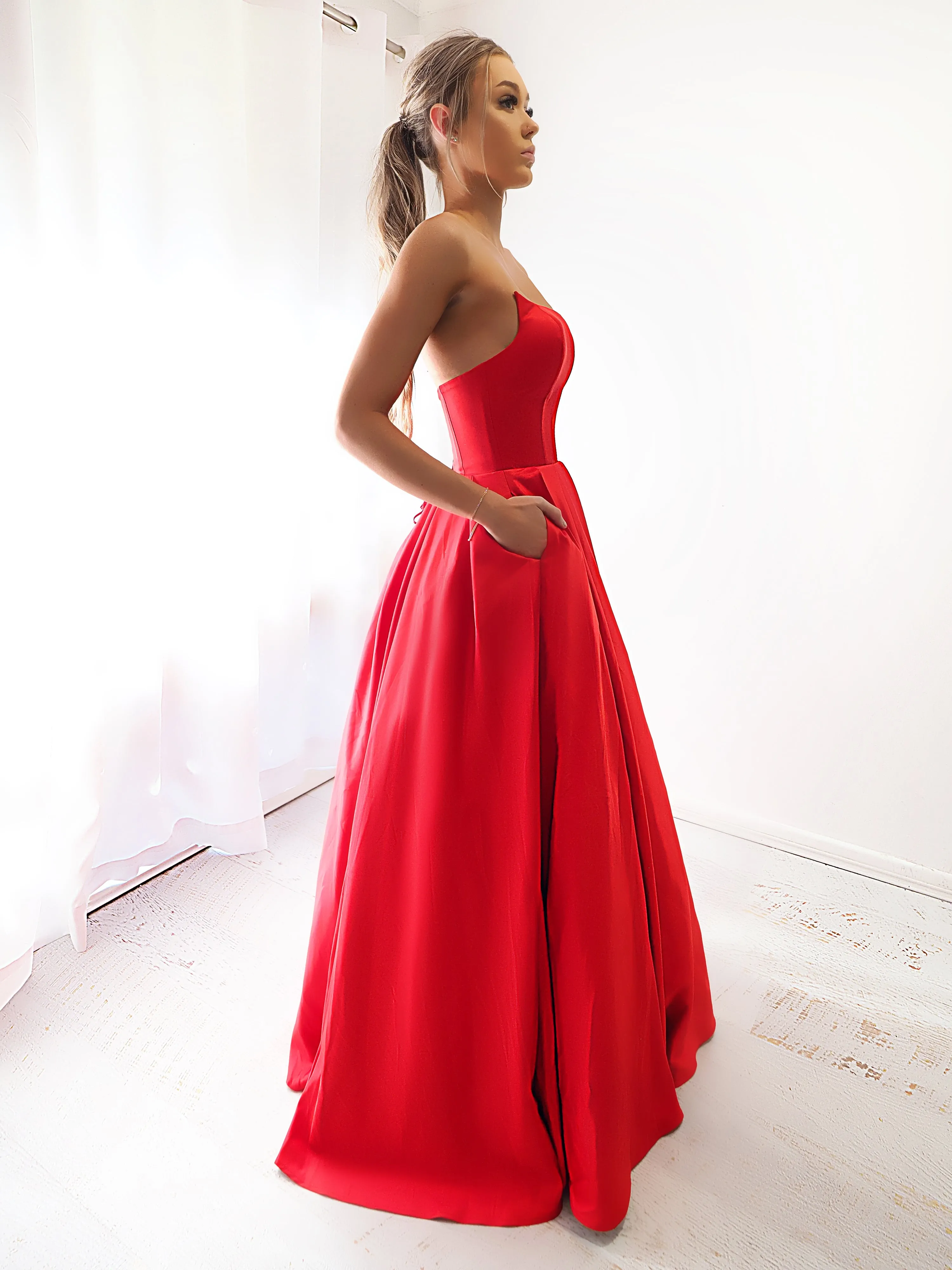 Bright red satin princess dress with crescent moon neckline