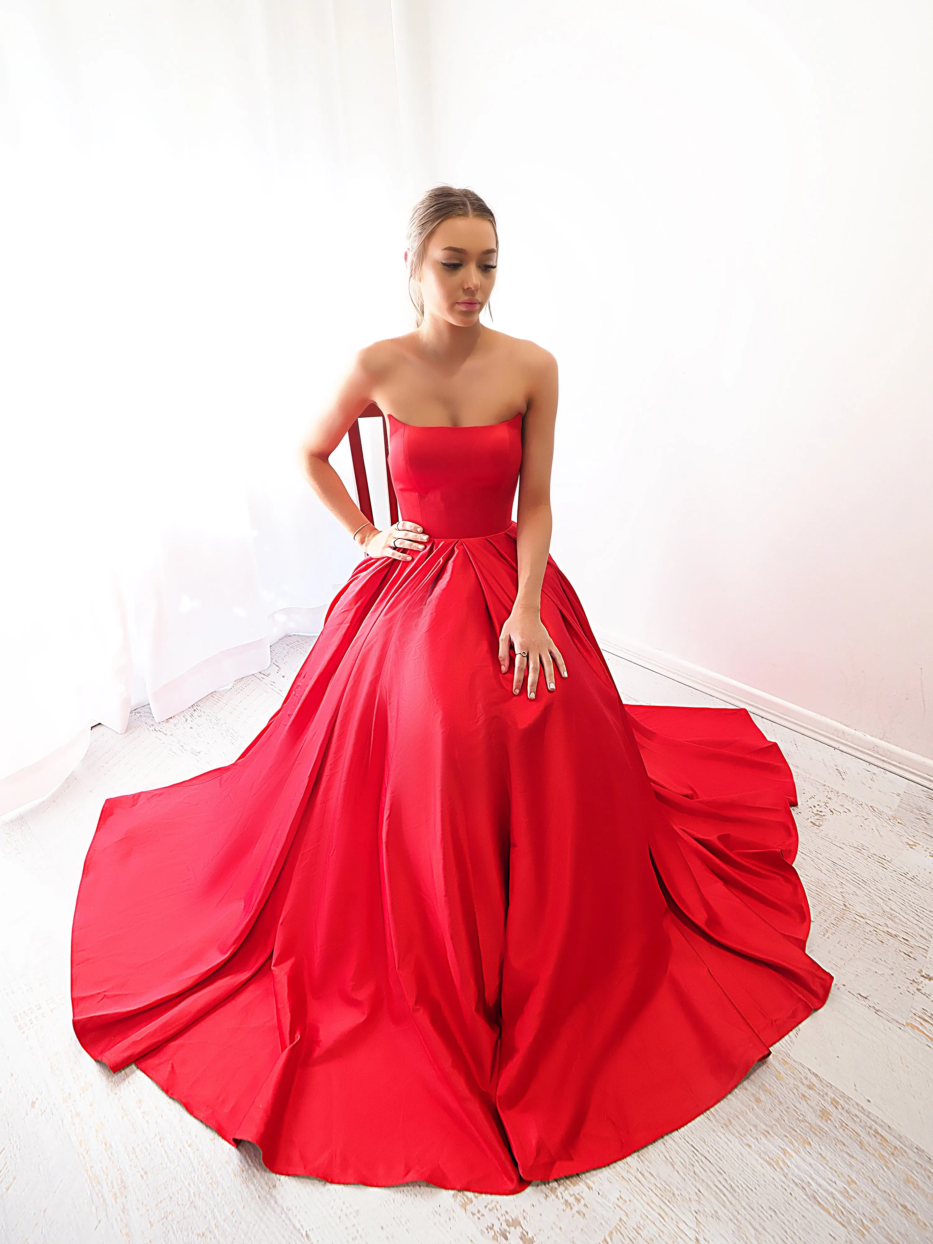 Bright red satin princess dress with crescent moon neckline